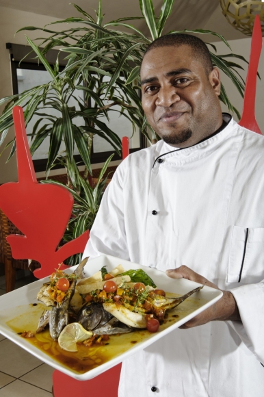 a chef presents his medley of seafood and local vegetables
