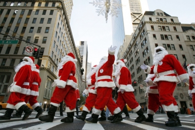 Sidewalk Santas from the Volunteers of America parade down Fifth Avenue