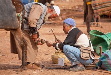 Local blacksmiths at work in a market near Imlil