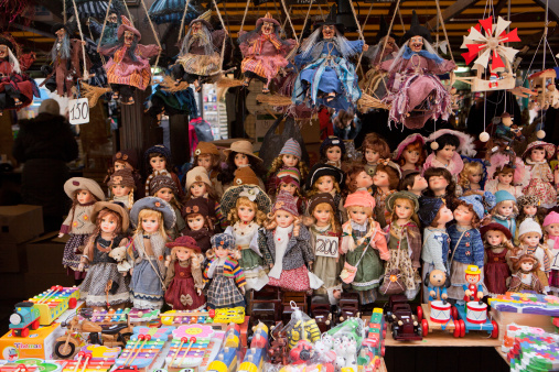 An assortment of puppets, toys and witches for sale