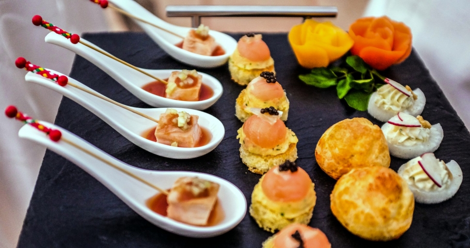 Canapes that include gougeres and smoked salmon domes on brioches