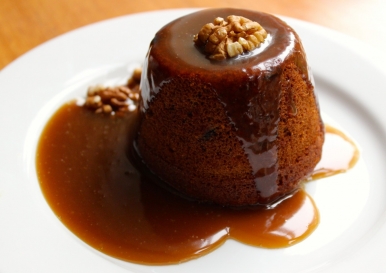 Sticky toffee pudding is a steamed dessert consisting of a very moist sponge cake, made with finely chopped dates, covered in a toffee sauce and often served with a vanilla custard or vanilla ice-cream
