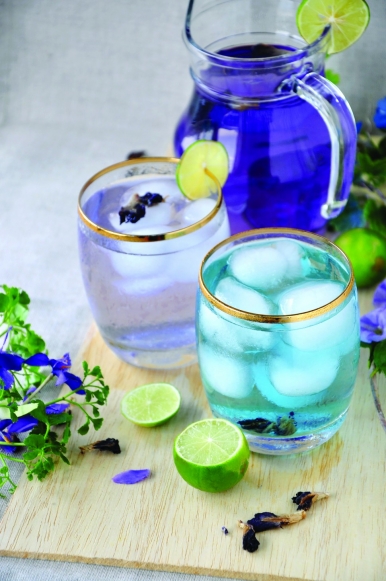 Extract from the butterfly pea flowers is added into a jar of fresh lime juice