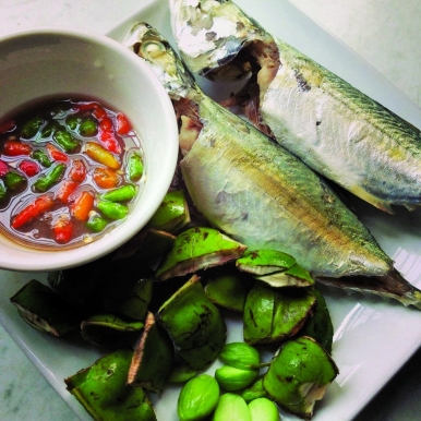 Raw petai eaten with steamed fish dipped in budu, a fish sauce made from anchovies