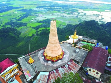 A drone shot of a pagoda atop Mount Zwegabin in Pha An, Myanmar