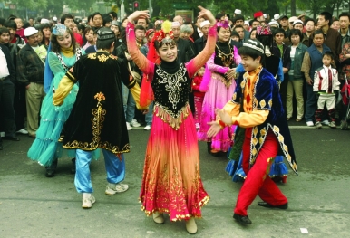 Uyghurs performing a traditional dance on the street as part of Eid celebrations