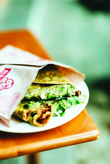 A crepe-like bread filled with egg, deep-fried batter crisp, coriander and scallion