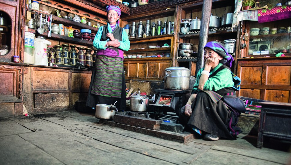 Local women cooking over a woodstove in Nile, Tsum Valley