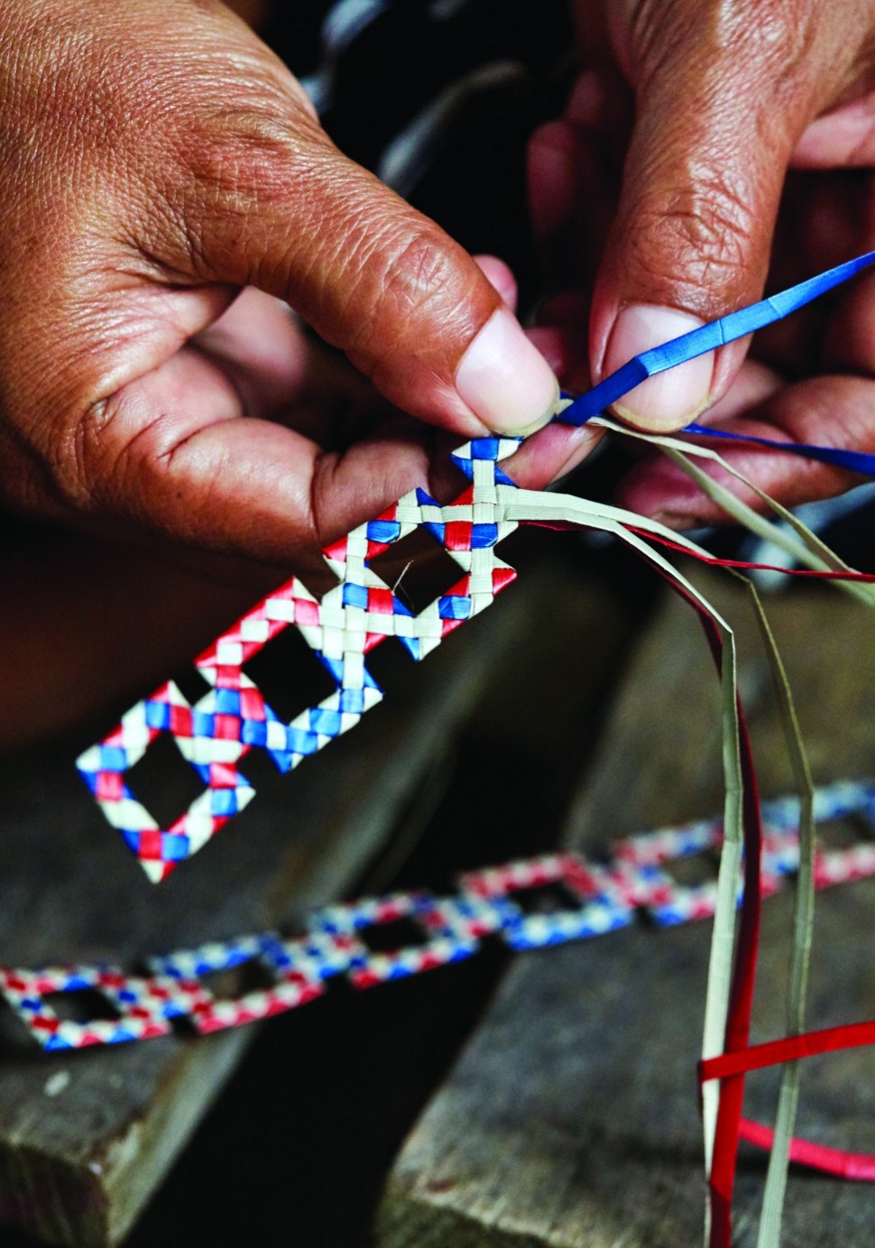 Weaving a wrist cuff, one of the customised items for Malaysia Airlines