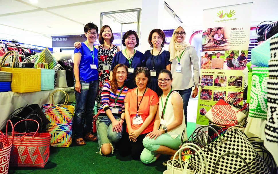Violette (standing, middle) and some of the Helping Hands Penan volunteers at a recent pop-up fair in Kuala Lumpur.