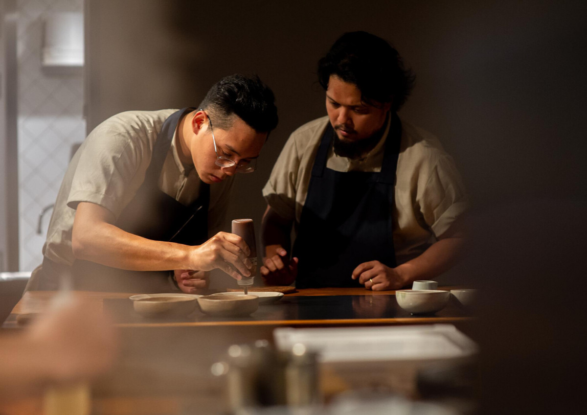 Dewakan's chef Darren Teoh (right) supervising a meal prep