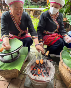 Women grilling stickyrice in Mueang Luang Nuea