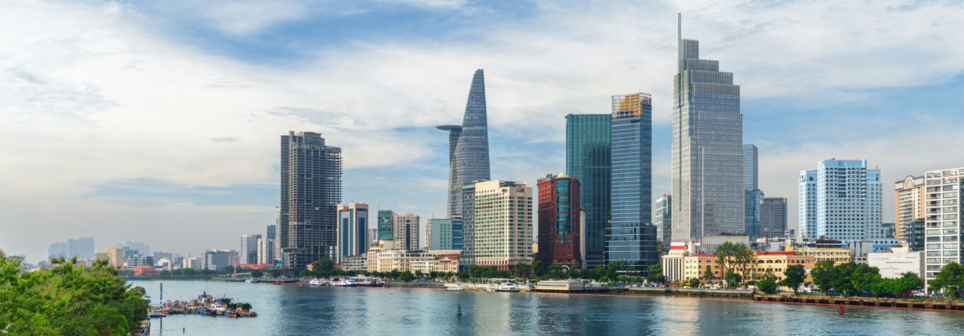 Amazing view of skyscrapers and other high-rise buildings reflected in water of the Saigon River at downtown of Ho Chi Minh City