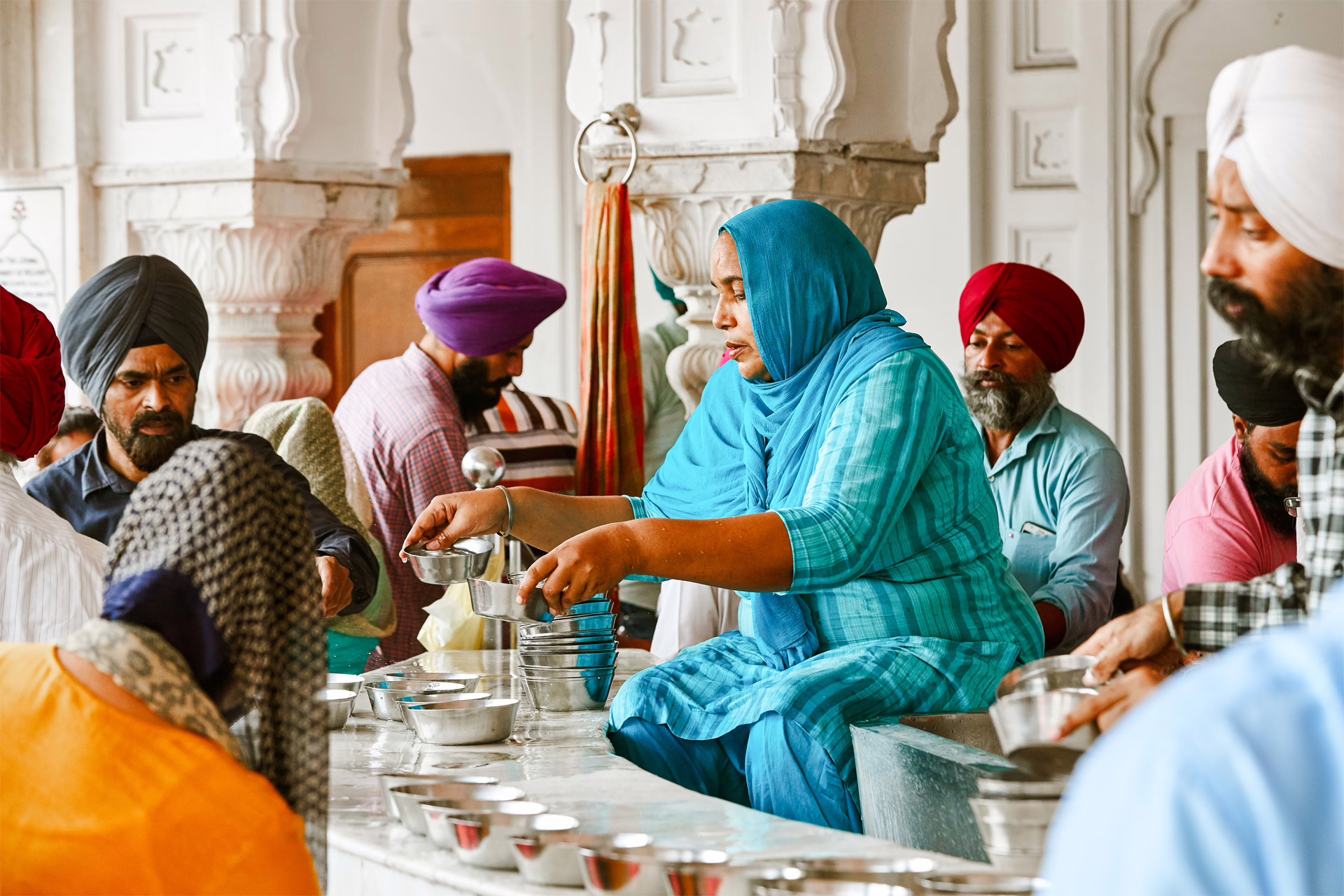 A woman serves waterto pilgrims at the Golden Temple’s langar